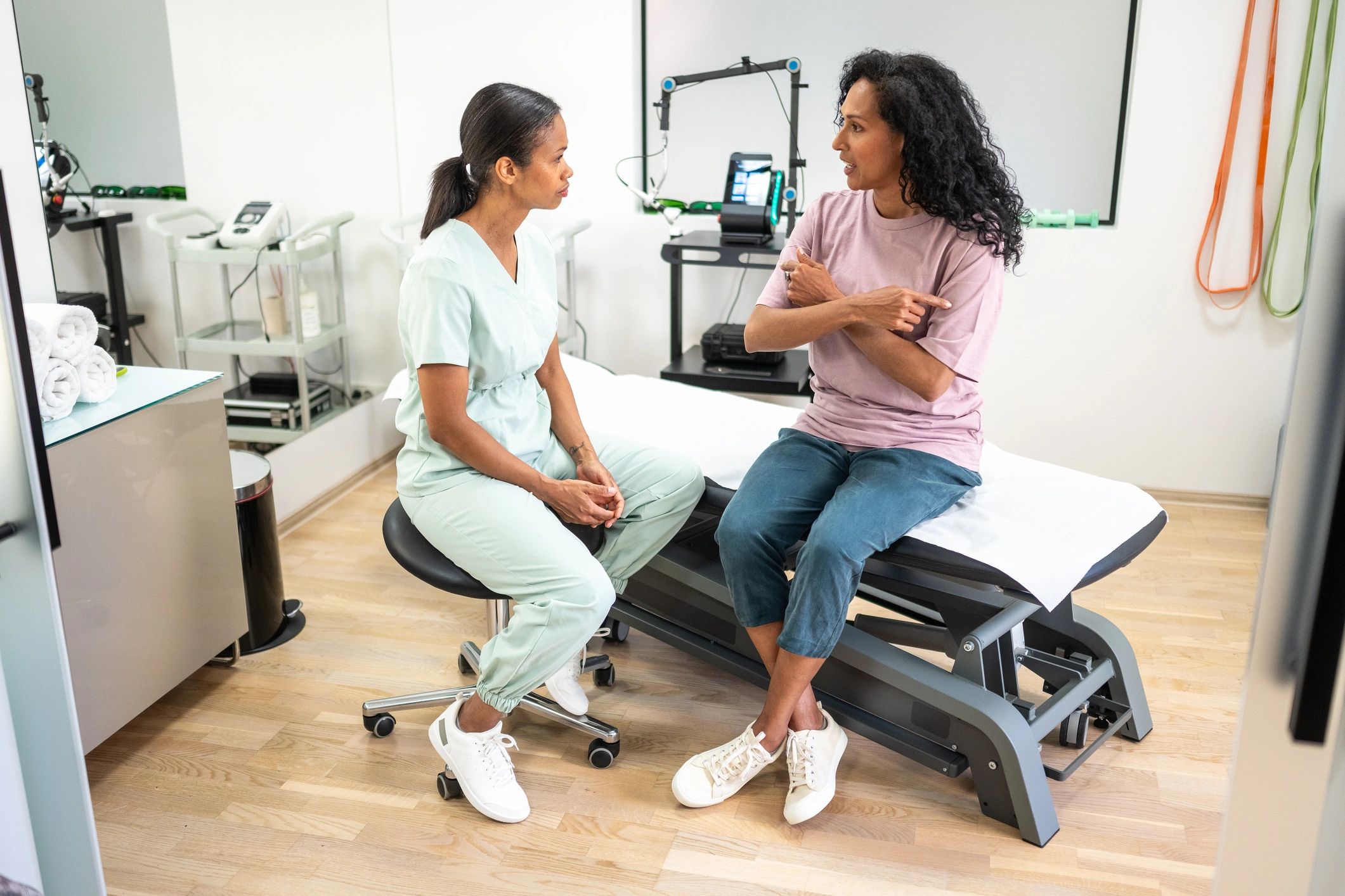 Clinician consulting with a patient in a modern medical setting